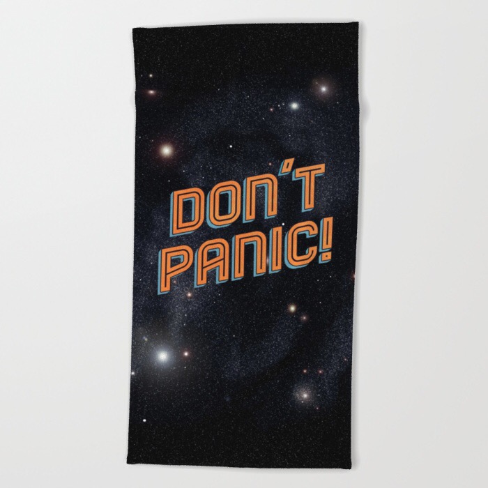 product photo of a beach towel with an image of space and the words DON'T PANIC in large, friendly letters